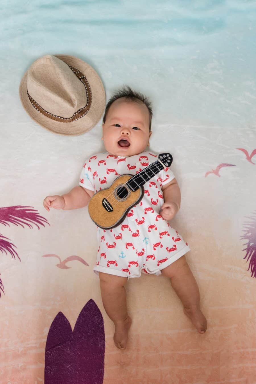 100 Days Baby Boy Beach Theme Floor Art playing ukulele