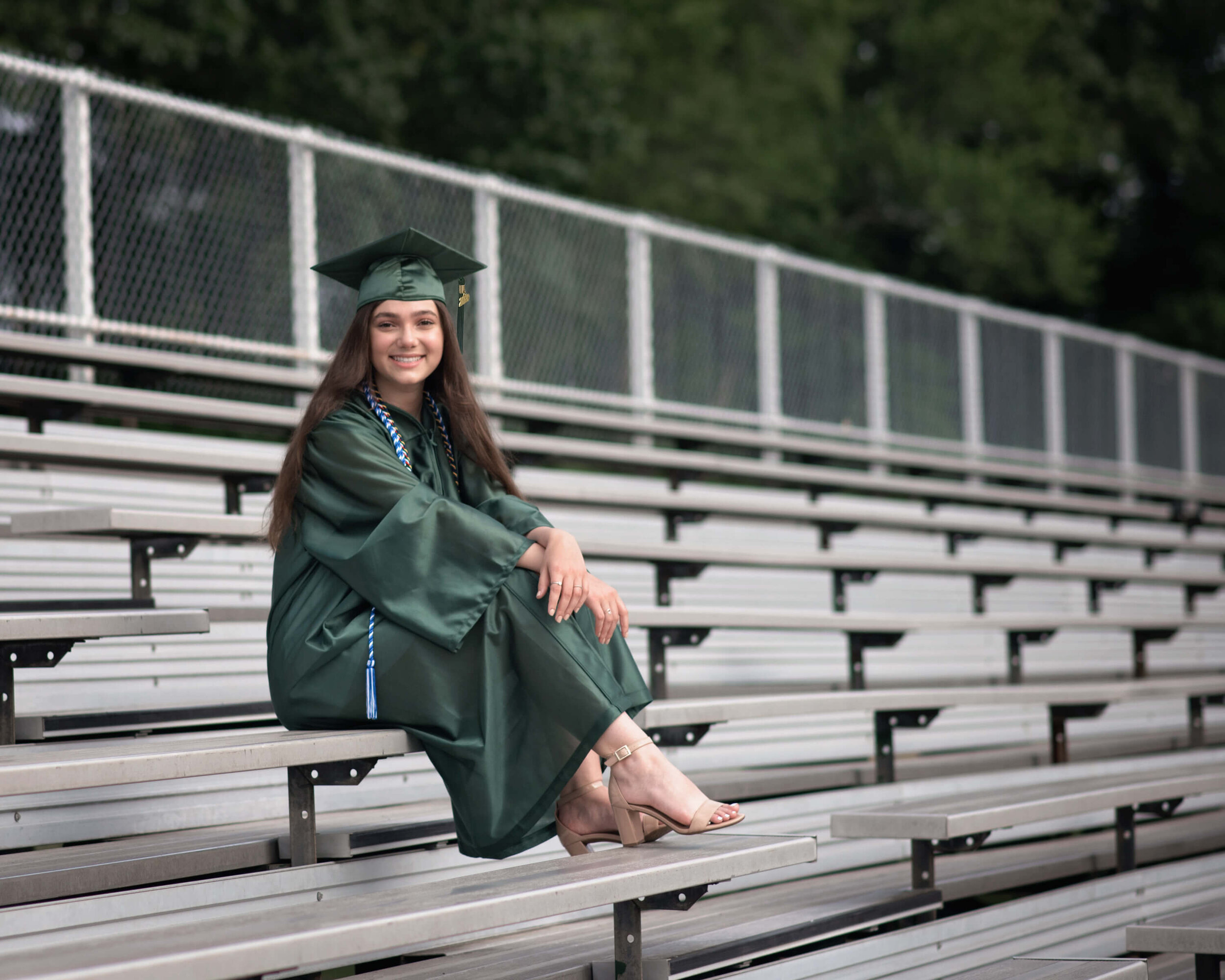 EBHS senior girl sitting on the bleacher by the athletic field
