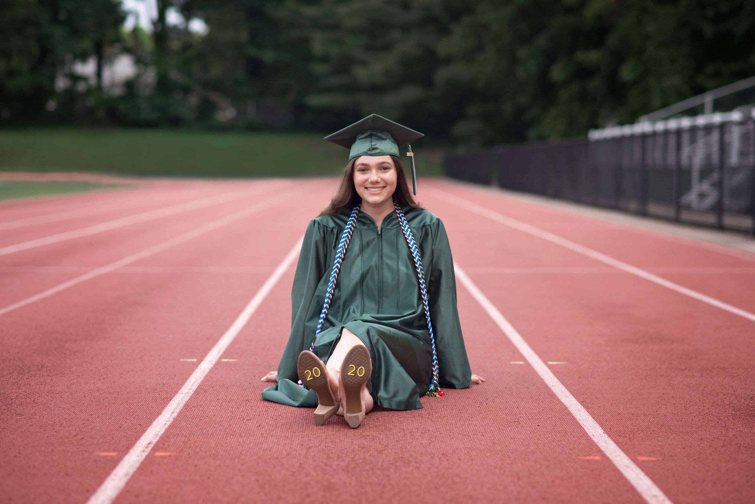 EBHS senior girl sitting on the athletic field track
